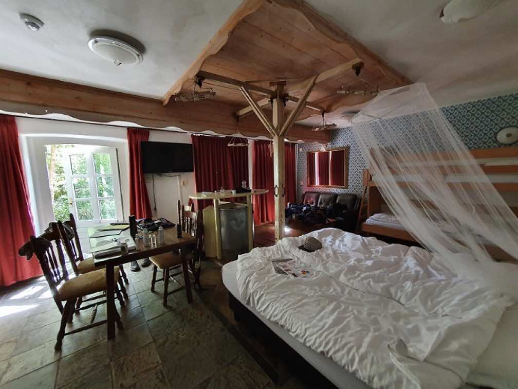 A luxury room with double bed, table and chairs